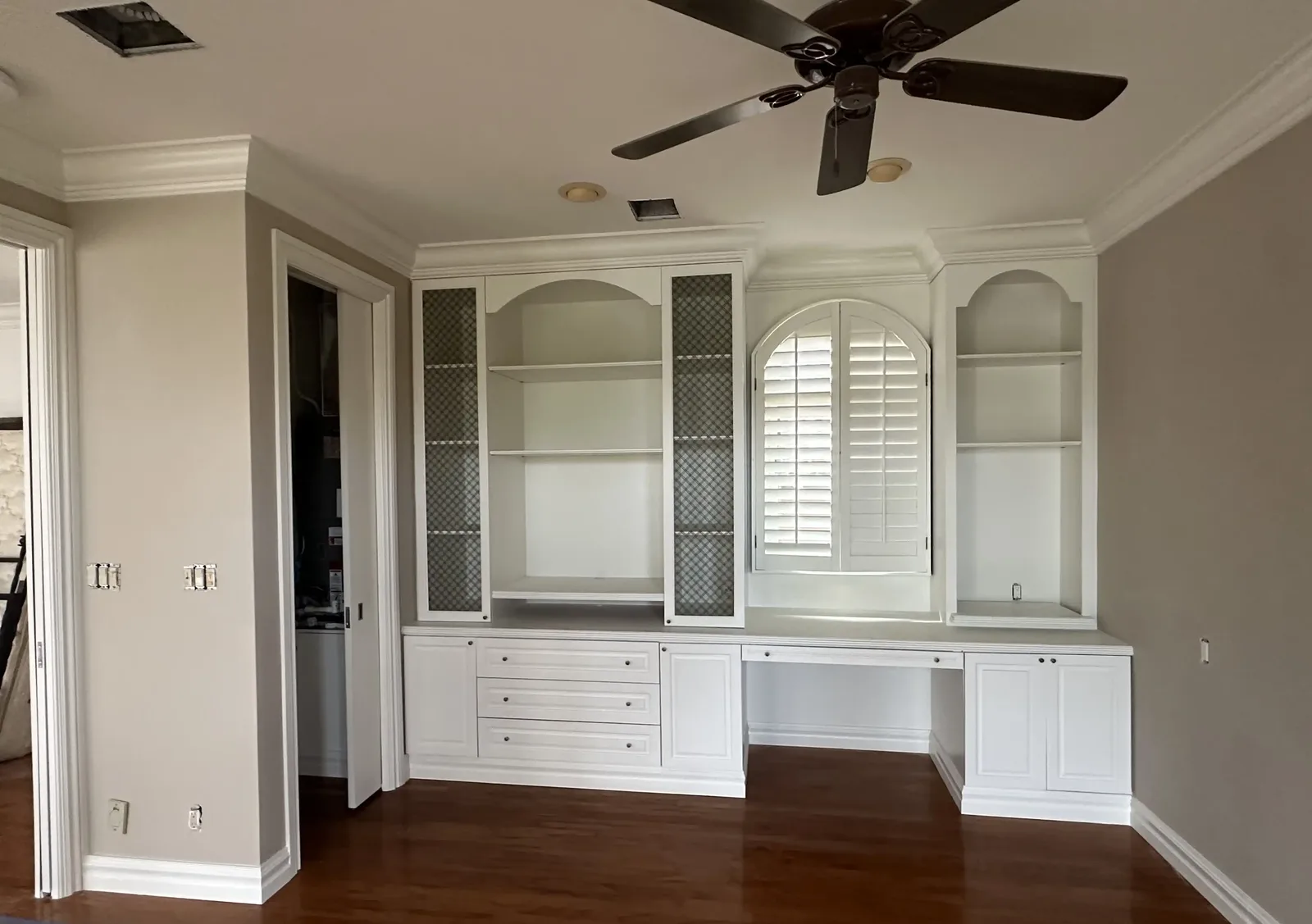 Freshly painted custom built-in cabinetry and shelving