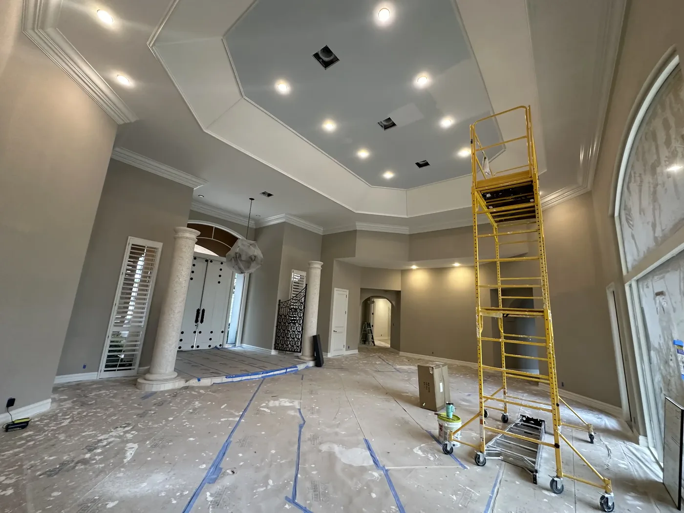 Room mid-renovation with surfaces prepped and protected